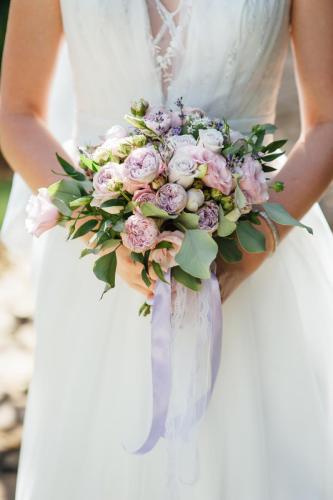 Bride holds a wedding bouquet, wedding dress, wedding details